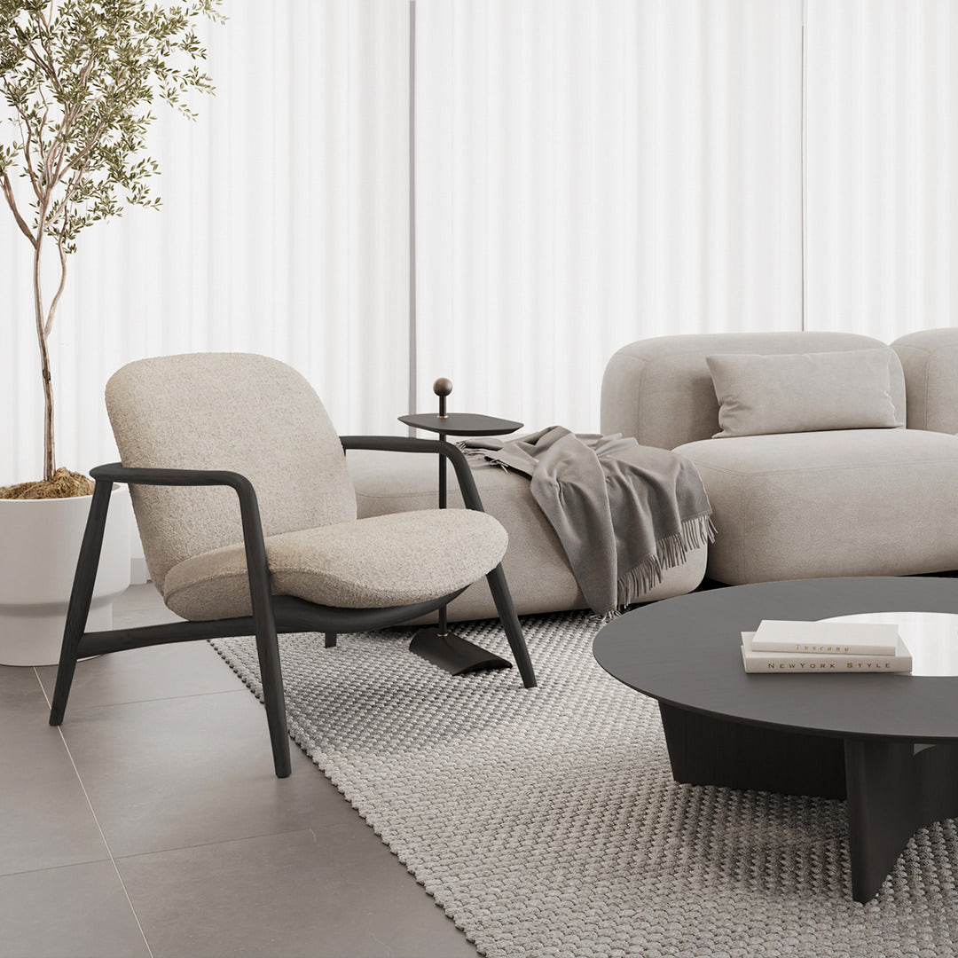 Modern living room with a beige sofa, armchair, and coffee table.