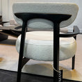 Load image into Gallery viewer, Modern chair with black legs and light gray cushioned seat in a minimalistic room.