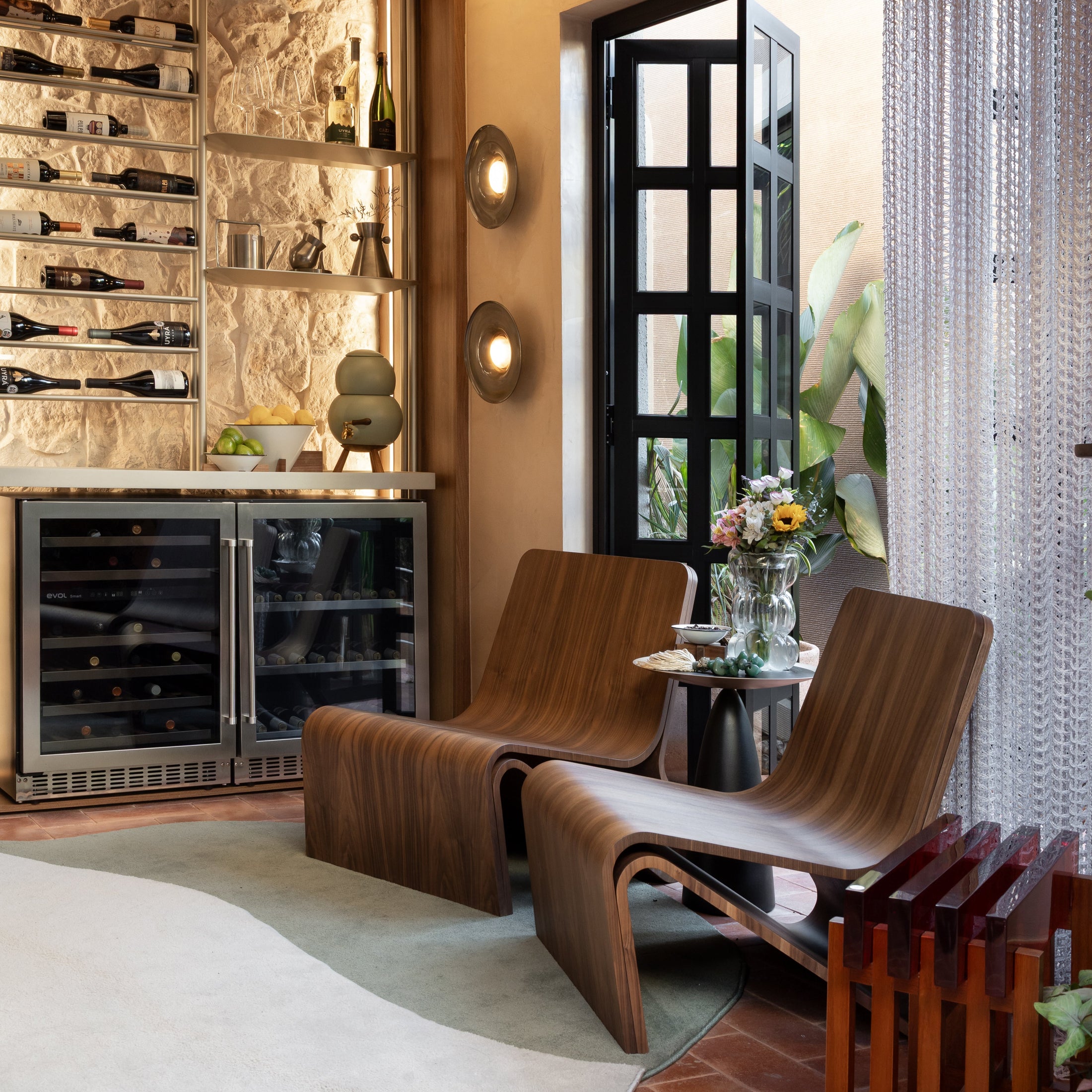 Modern interior with wooden lounge chairs, wine rack, and decorative elements.