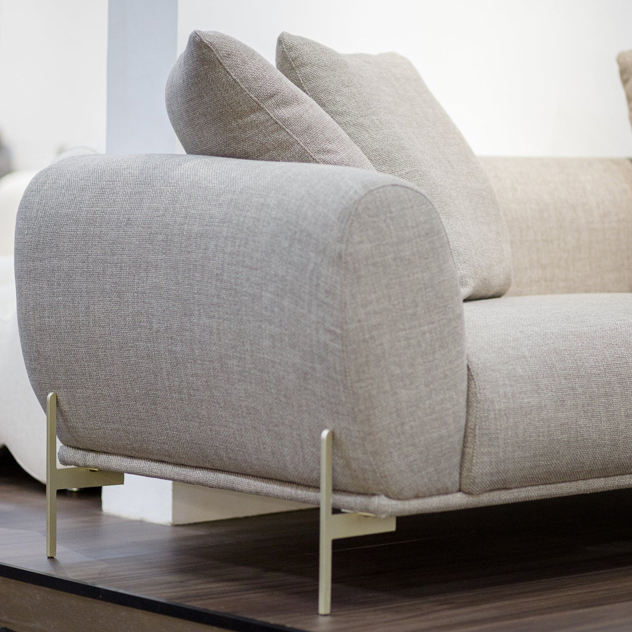 Gray sofa with beige cushions in a minimalistic room