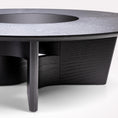 Load image into Gallery viewer, Round black coffee table with a textured surface on a white background
