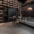 Load image into Gallery viewer, Modern kitchen with dark wood cabinets and a bar area.