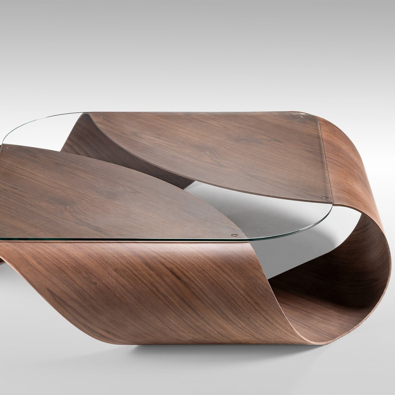 sculptural coffee table in walnut finish, organic shape with glass top