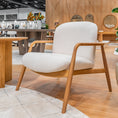 Load image into Gallery viewer, White armchair with wooden frame in a modern indoor setting
