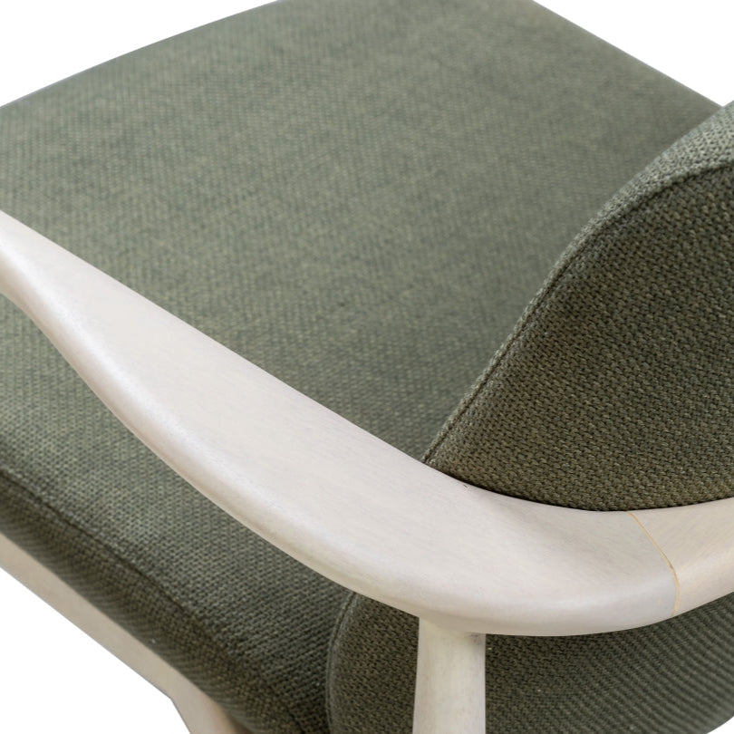 Green upholstered armchair with white frame on a white background