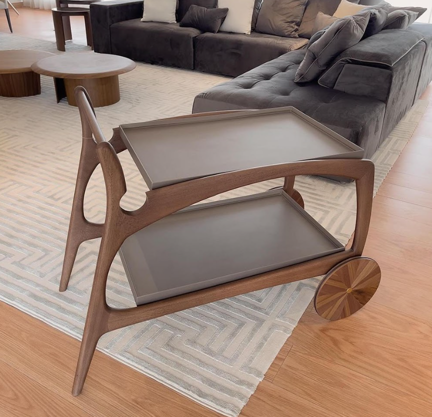 Wooden serving cart with trays in a living room setting
