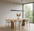 Load image into Gallery viewer, Modern dining room with wooden table and white chairs near a large window.