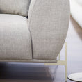 Load image into Gallery viewer, Gray upholstered sofa with a metallic base on a wood surface.