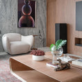 Load image into Gallery viewer, Modern living room with a white armchair, marble wall, and wooden coffee table.