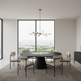 Load image into Gallery viewer, Modern dining room with a round table and chairs in a stylish interior.