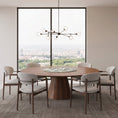 Charger l'image dans la visionneuse de la galerie, A modern dining room setup featuring a round wooden dining table with a glass center insert, surrounded by six upholstered wooden chairs with dark wood frames. A contemporary multi-arm chandelier hangs above the table, set against a large window with a city view.