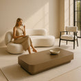 Load image into Gallery viewer, Woman sitting on a modern white chair in a minimalistic room with a coffee table and bowl.