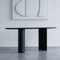 Load image into Gallery viewer, Modern black dining table in a minimalistic room with abstract art on the wall.