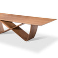 Load image into Gallery viewer, A modern dining table with a unique infinity symbol shaped base and a wooden tabletop.