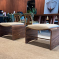 Load image into Gallery viewer, Modern wooden chairs with beige cushions in a room with a mirror and artwork on the wall.