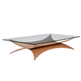 Load image into Gallery viewer, A modern rectangular coffee table with a clear glass top and a sculptural curved wooden base in a warm oak finish, shown on a plain white background.
