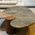 Load image into Gallery viewer, Modern coffee table with marble top and wooden base in a living room setting

