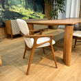 Load image into Gallery viewer, Wooden chair with white cushion on a wooden floor
