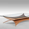 Load image into Gallery viewer, A modern rectangular glass-top coffee table with a sculptural curved wooden base in a warm medium brown tone, photographed on a clean light gray studio background.
