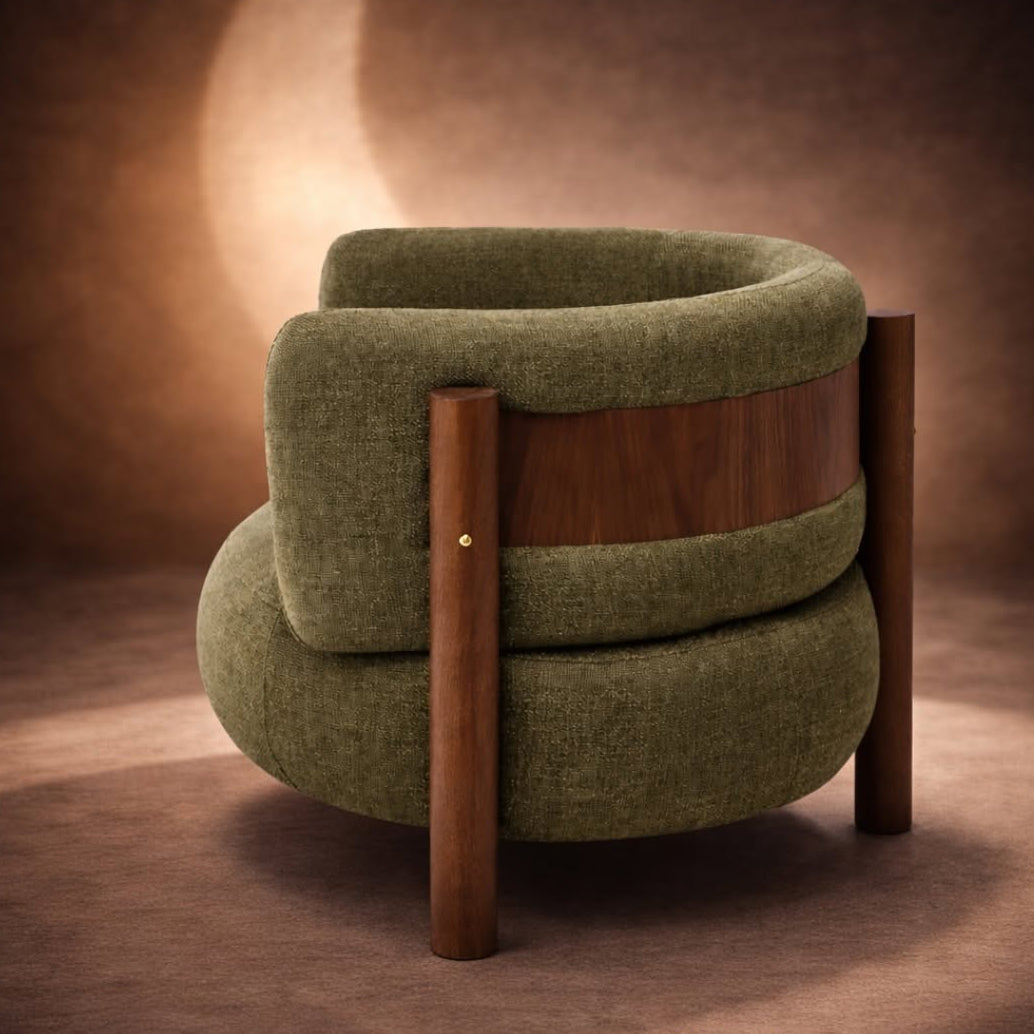 Green armchair with wooden frame on a brown background, featuring Salone del Mobile Milano logo.