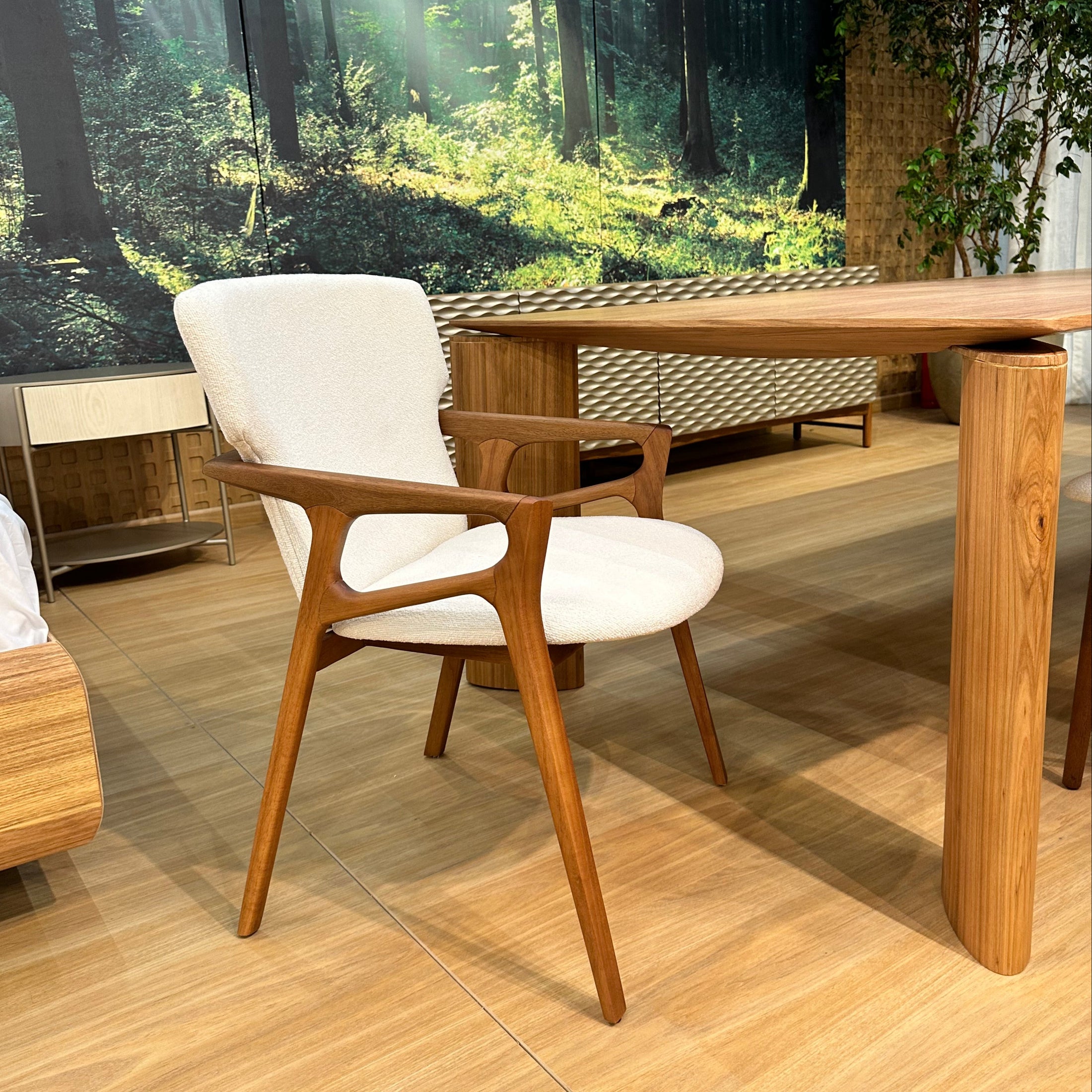 Wooden chair with white cushion on a wooden floor