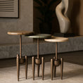 Load image into Gallery viewer, Set of three small round tables with wooden tops and metal legs in a room setting.
