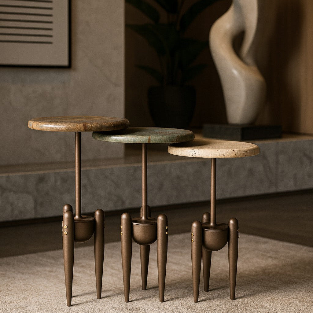Set of three small round tables with wooden tops and metal legs in a room setting.