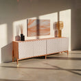 Load image into Gallery viewer, A sideboard with a smooth, lacquered finish with four doors, set on a white light backround.
