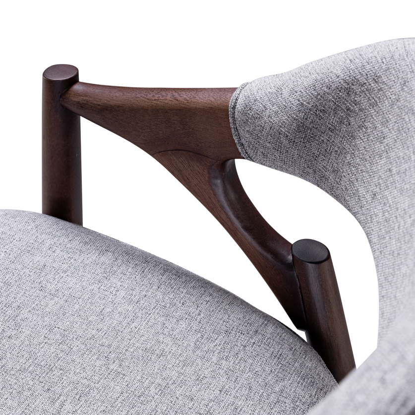Gray upholstered chair with wooden armrests on a white background