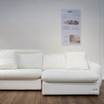 Load image into Gallery viewer, White sectional sofa in a room with a poster on the wall.
