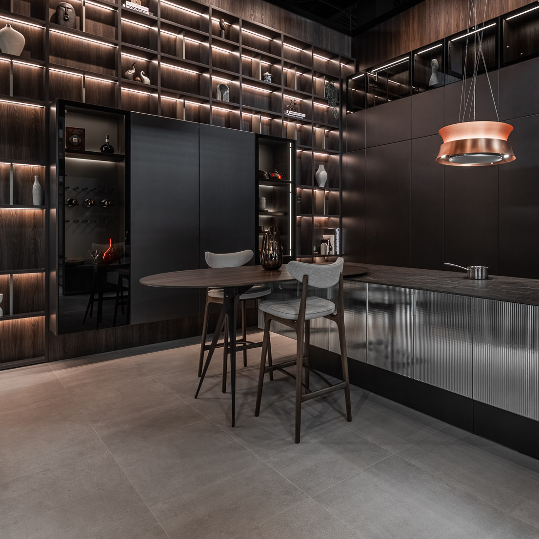 Modern kitchen with dark wood cabinets and a bar area.