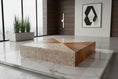 Load image into Gallery viewer, Modern coffee table with marble and wood design in a stylish room.
