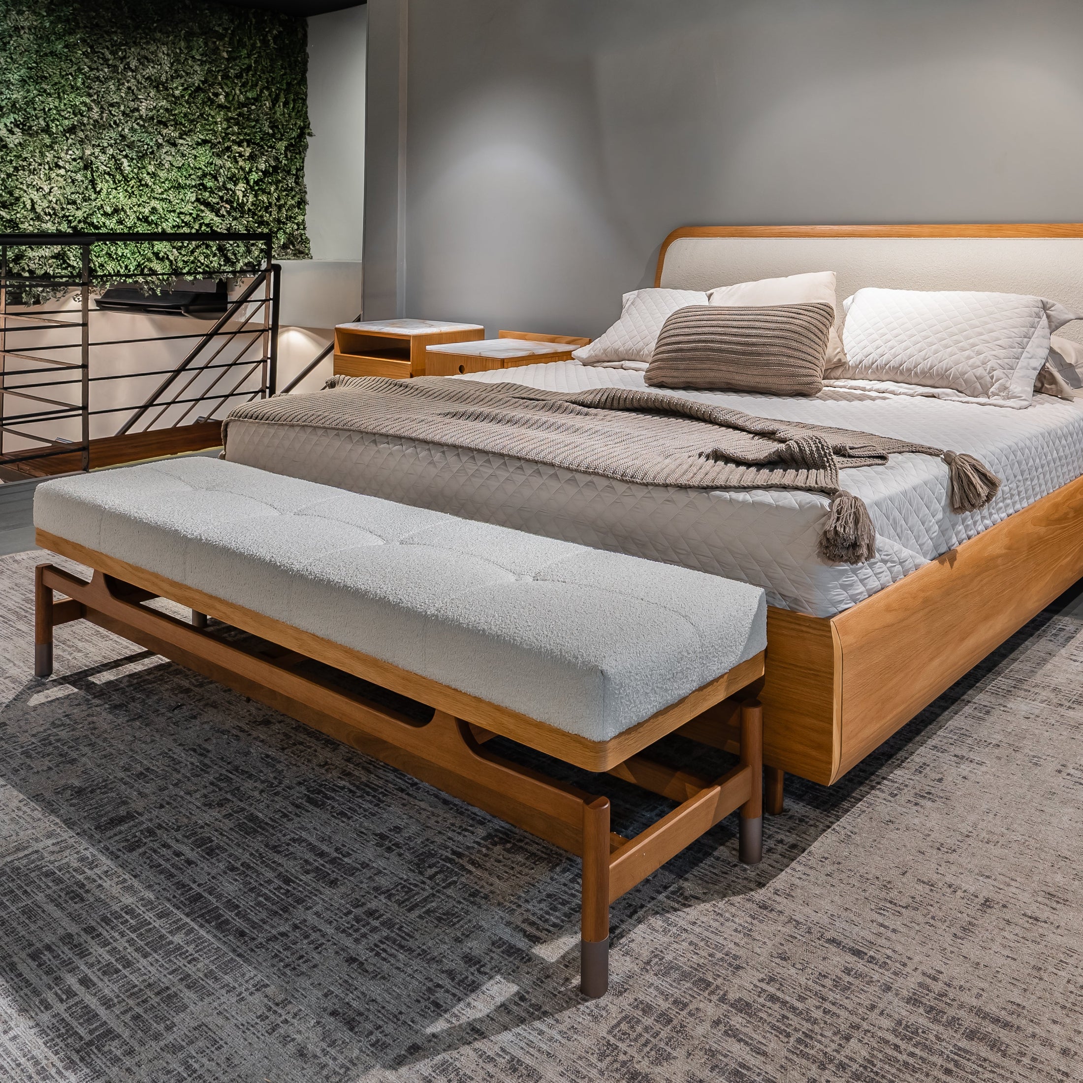 Modern bedroom with wooden bed , modern bench and gray bedding