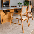 Load image into Gallery viewer, Dining area with wooden table and chairs in a modern interior setting.

