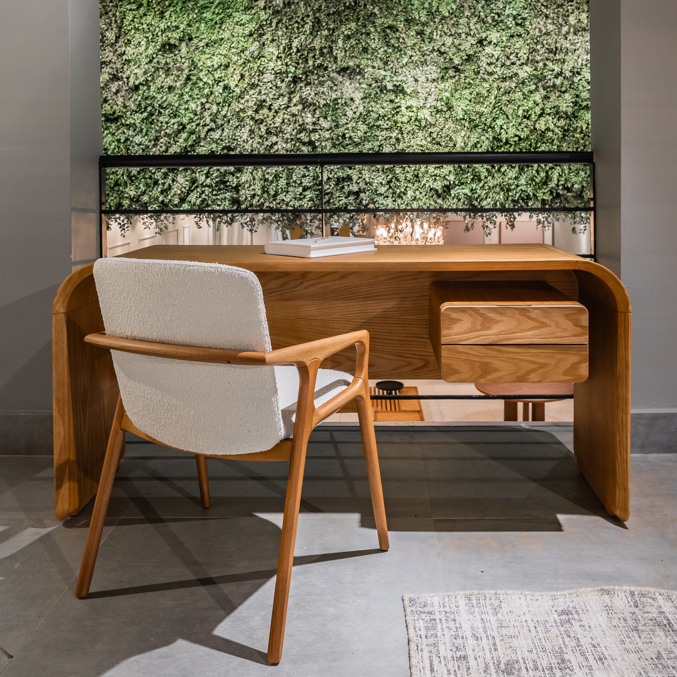 Wooden desk with white chair in a room with a green wall