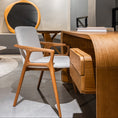 Load image into Gallery viewer, Modern office interior with wooden desk and chair, round mirror, and gray walls.
