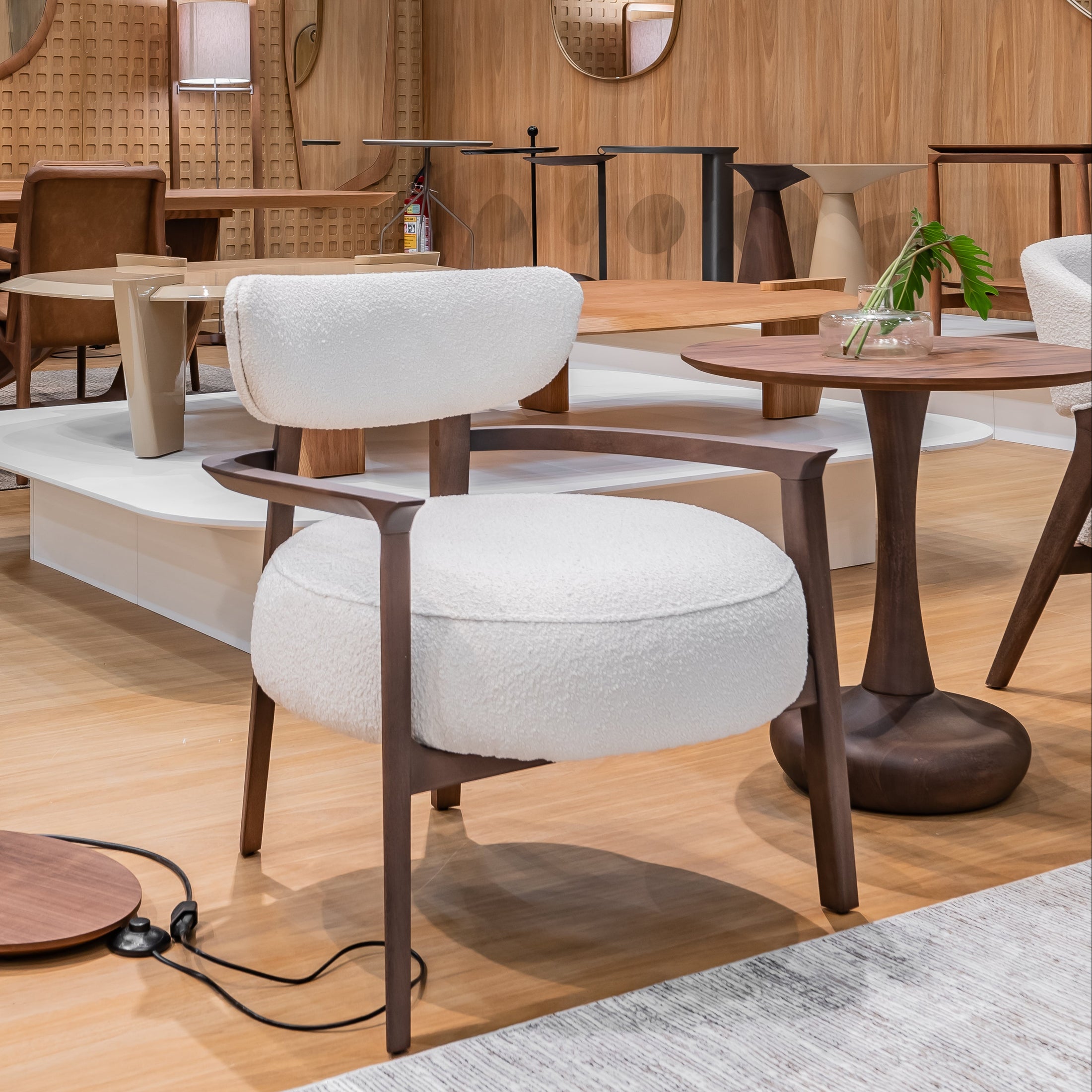 Modern interior design with wooden walls, tables, and chairs.
