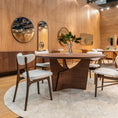 Load image into Gallery viewer, Dining room with wooden table and chairs in a modern interior setting.

