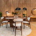 Load image into Gallery viewer, Dining area with wooden table and chairs in a showroom setting
