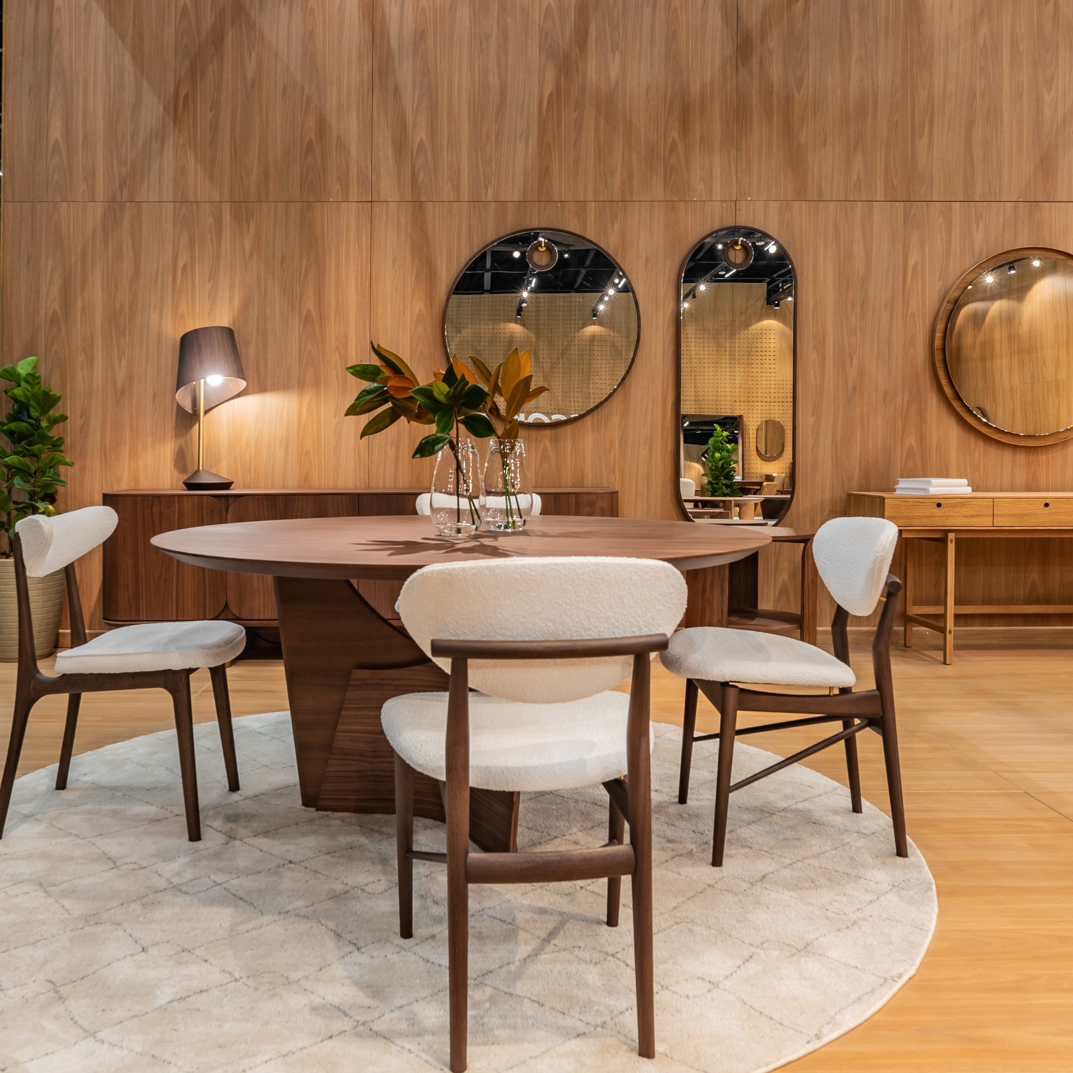 Dining area with wooden table and chairs in a showroom setting