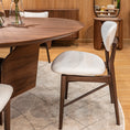Load image into Gallery viewer, Dining area with wooden table and chairs against a wooden wall with mirrors.
