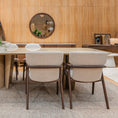 Load image into Gallery viewer, Dining area with a large wooden table and chairs in a room with wooden walls and mirrors.
