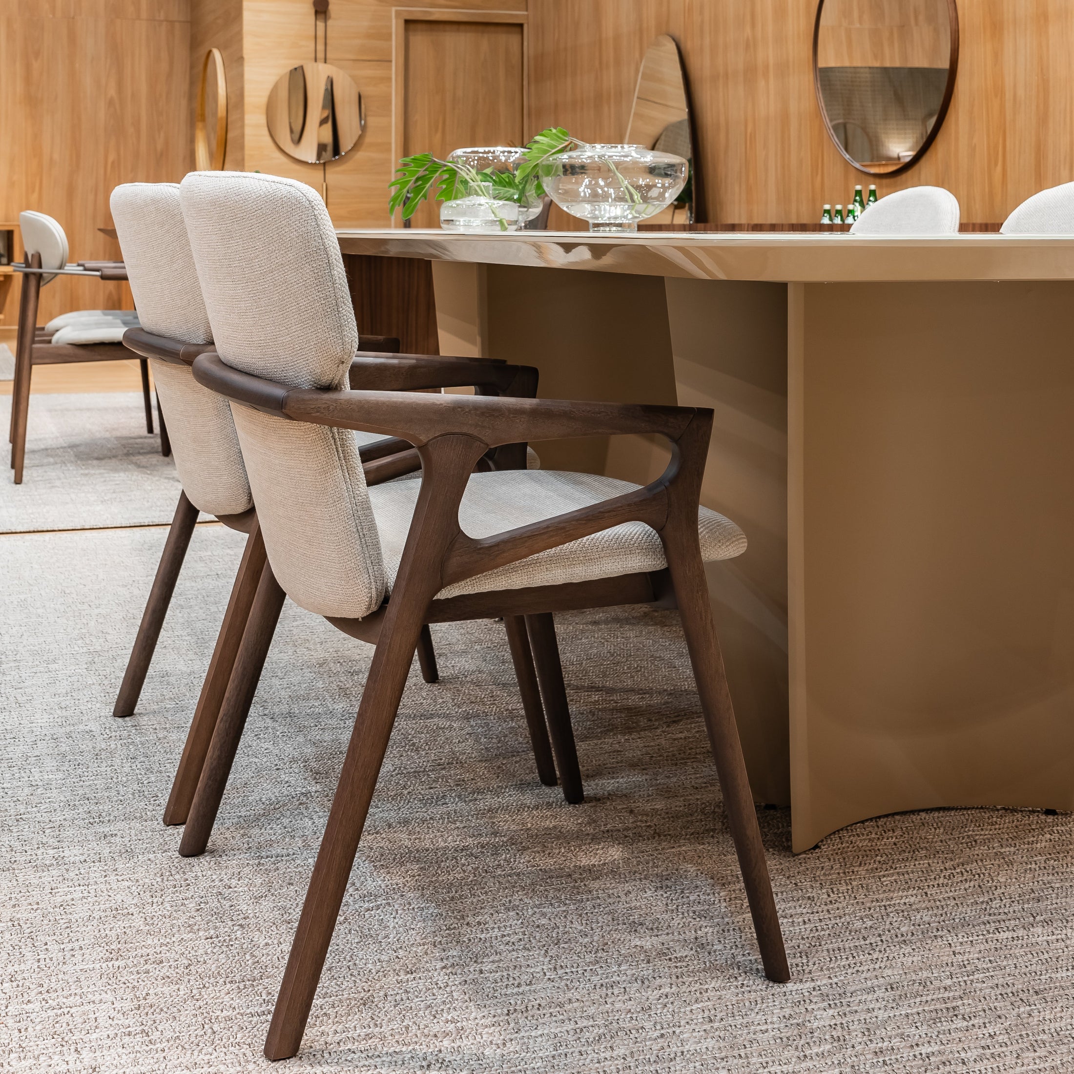 Dining area with wooden table and chairs in a modern interior setting.