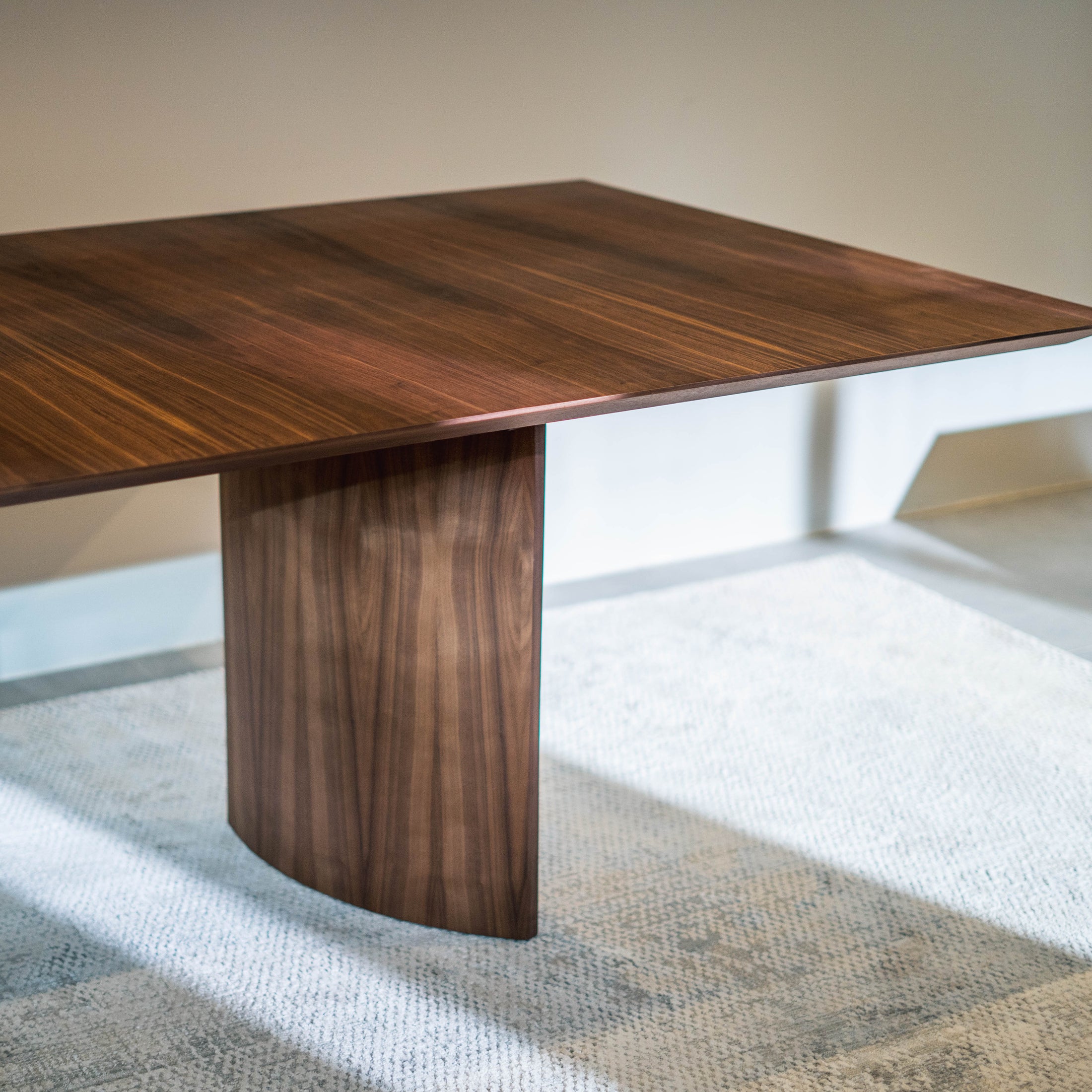 Wooden dining table with a modern design in a minimalistic room.