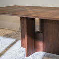 Load image into Gallery viewer, Wooden dining table in a room with a rug and neutral wall.
