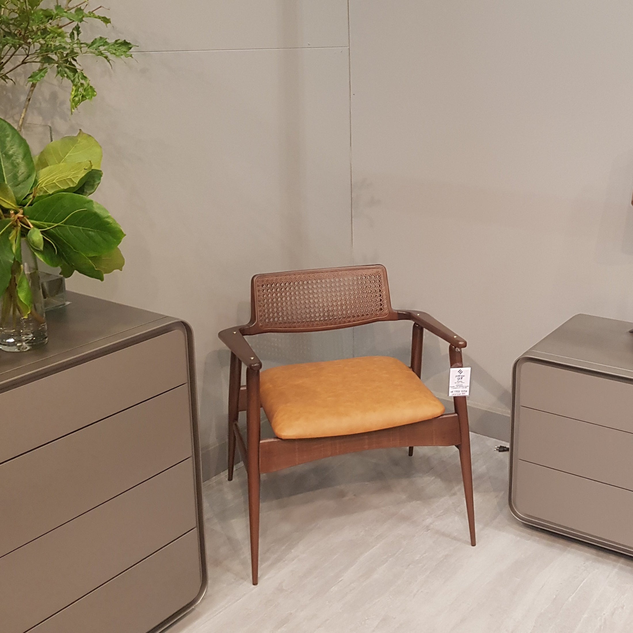 Modern interior with a chair, side table, and lamp against a neutral wall.