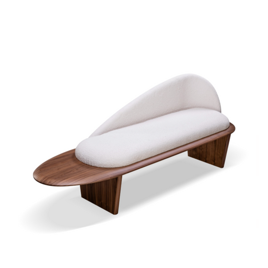 A beige upholstered bench with a smooth, flowing line design and a extended backrest, set against a white background.