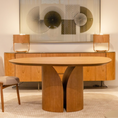 Load image into Gallery viewer, Dining room with wooden table and chairs, and a decorative wall piece.
