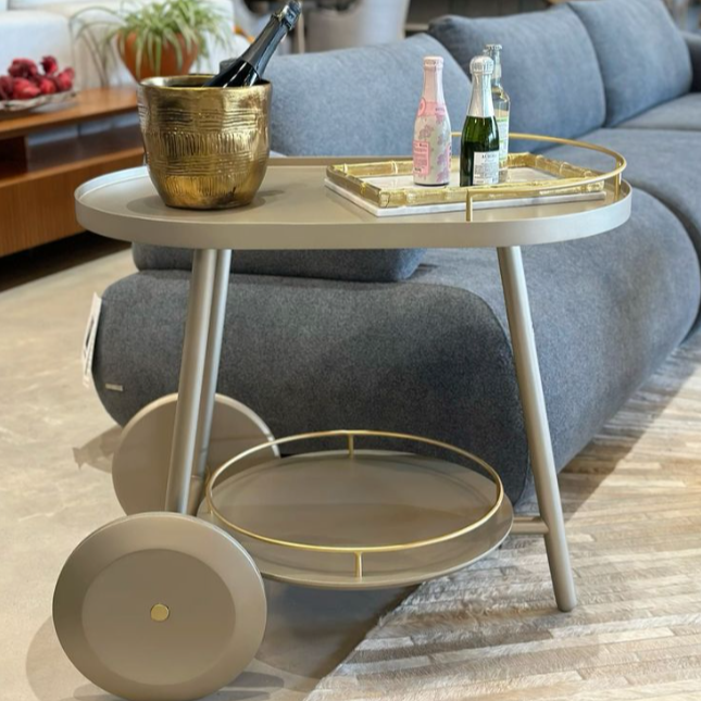 Decorative bar cart with gold accents in a living room setting