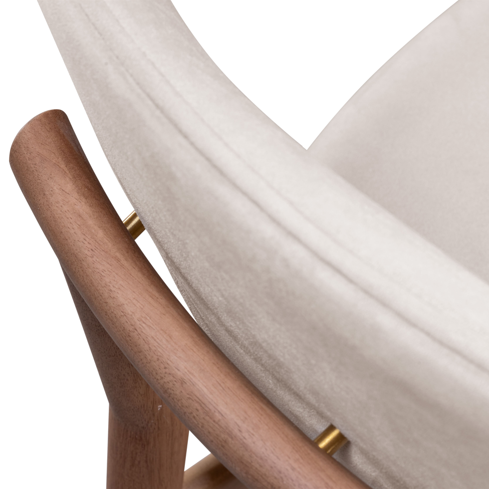 Close-up of a wooden chair with a white cushion on a white background